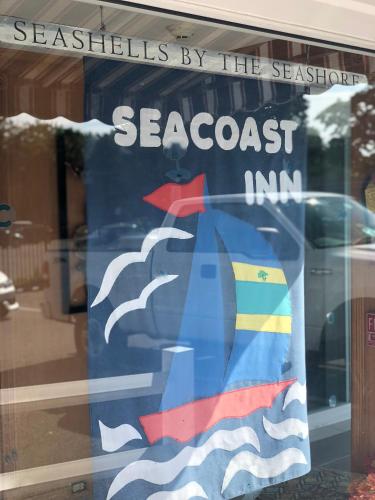 a sign in the window of a seafood restaurant at SeaCoast Inn in Hyannis