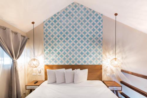 a bedroom with a white bed and a blue wall at Quinta Margarita - Boho Chic Hotel in Playa del Carmen