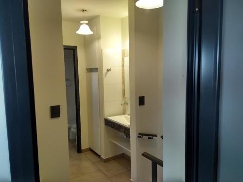 a bathroom with a toilet and a sink at Complejo Megevand in Río Ceballos