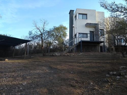 a large white building on top of a field at Complejo Megevand in Río Ceballos