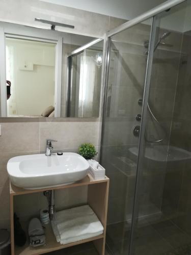 a bathroom with a sink and a shower at Guest House B&B Via Marina in Reggio Calabria