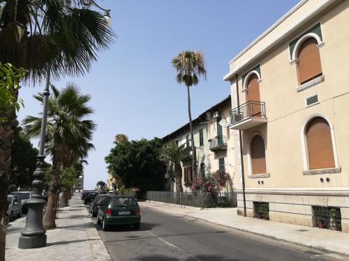 a street with cars parked on the side of a building at Guest House B&B Via Marina in Reggio Calabria