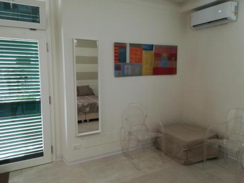 a room with a mirror and a bed in it at Guest House B&B Via Marina in Reggio Calabria