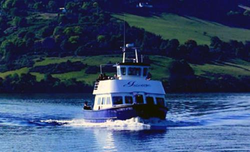a boat in the water on a lake at Loch Ness Clansman Hotel in Drumnadrochit