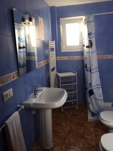 ein blaues Bad mit einem Waschbecken und einem WC in der Unterkunft Chalet Son Serra in Son Serra de Marina