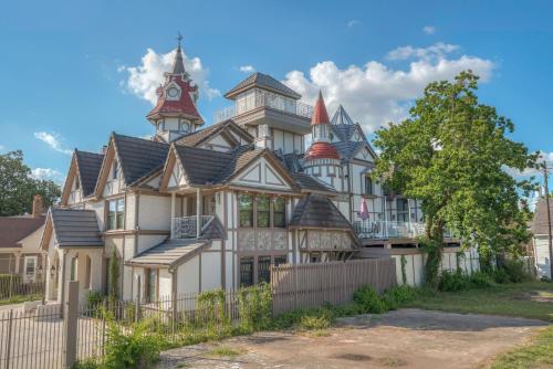 a large white house with turrets at Houston Towers Inn, Adults-Only, Downtown, Med Ctr, NRG in Houston