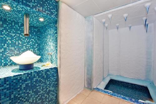 a bathroom with a sink and a shower at Balneo Complex & Spa Aquatonik in Velingrad