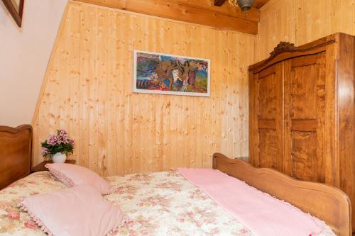 a bedroom with a bed and a painting on the wall at Windmill vacation home in Ledzin near Baltic Sea in Niechorze