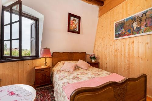 a bedroom with a bed and a window at Windmill vacation home in Ledzin near Baltic Sea in Niechorze