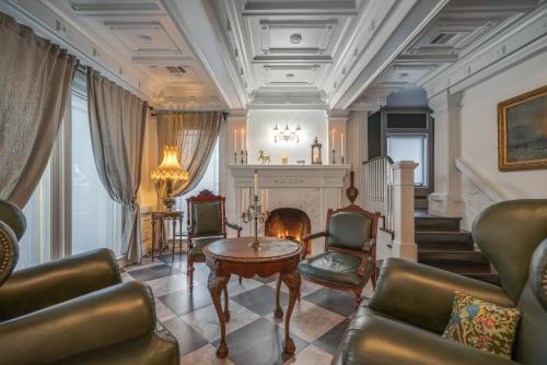 a living room with a table and chairs and a fireplace at Houston Towers Inn, Adults-Only, Downtown, Med Ctr, NRG in Houston