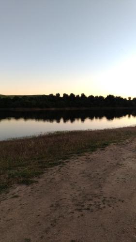 a body of water with trees in the background at Route 2 Torrão in Torrão