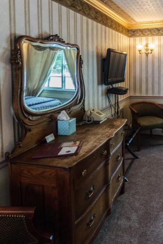 a dresser with a large mirror on top of it at Frisco Lodge in Frisco