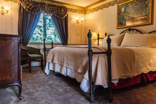 a bedroom with a bed and a chair and a window at Frisco Lodge in Frisco
