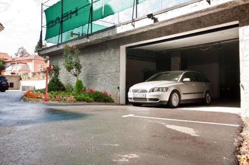 a white car is parked inside of a garage at Balneo Complex & Spa Aquatonik in Velingrad