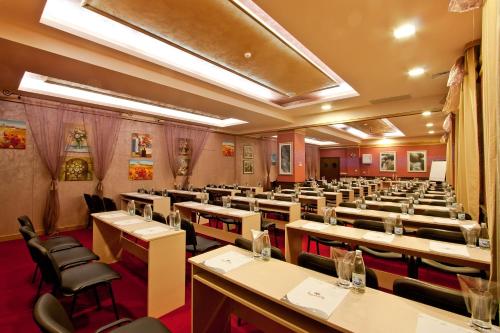 a dining room with rows of tables and chairs at Balneo Complex & Spa Aquatonik in Velingrad