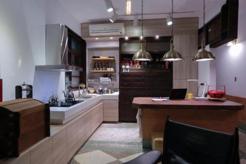 a kitchen with a counter and a sink and a stove at Chung Fu Inn in Tainan