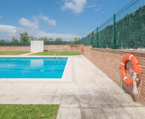 a swimming pool with an orange apparatus next to a fence at Hotel Platja d'Aro in Platja  d'Aro