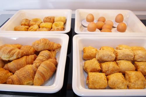 three plastic trays of food with eggs in them at Breeze Boutique Athens by Prima Hotels in Athens