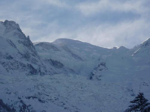 a snow covered mountain range with mountains in the background at Chalet Altitude 1057 in Chamonix