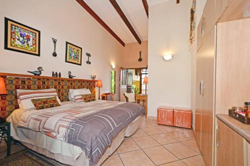 a bedroom with a large bed in a room at Cherry Tree Cottage B&B Linden in Johannesburg