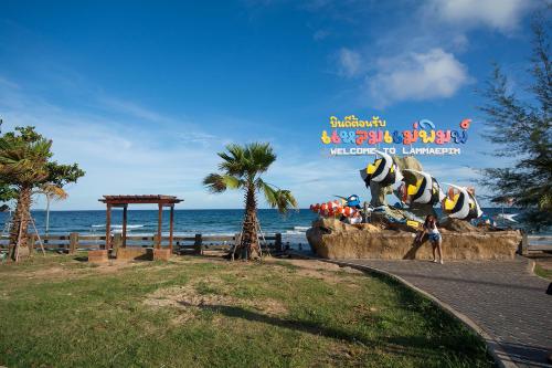 a sign for a water park next to the ocean at Mosaic Condminum A24m by malai in Mae Pim