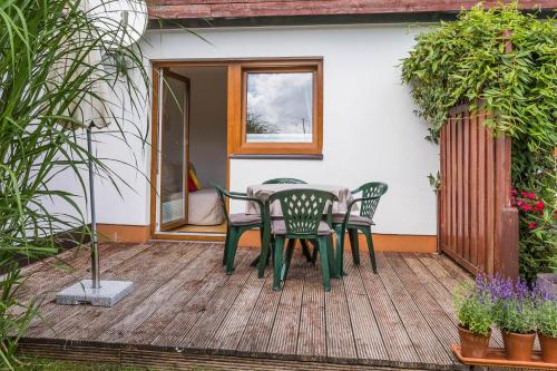 a patio with a table and chairs on a deck at Ferienwohnung Arndt in Fulpmes