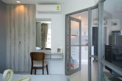 a living room with a couch and a chair in a room at Grandblue Condo 410 in Mae Pim