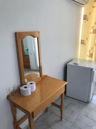 a table with a mirror and two rolls of toilet paper at Guesthouse in Chernomorets next to Gradina and Sozopol in Chernomorets