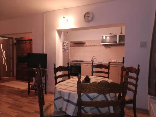 a room with a table and a kitchen with a table and chairs at Five in Luduş
