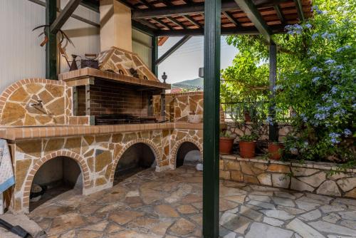 a patio with an outdoor oven in a house at Maria Studios in Keri