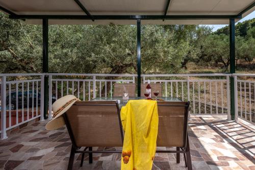 a table with a yellow blanket on a deck at Maria Studios in Keri
