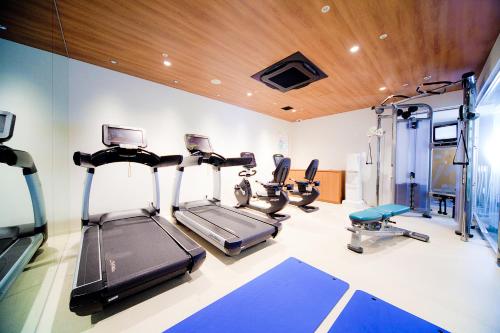 a gym with treadmills and ellipticals in a room at RIHGA Royal Hotel Kyoto in Kyoto
