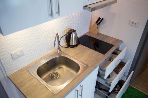 a kitchen counter with a sink in a kitchen at Grandblue Condo by malai in Mae Pim