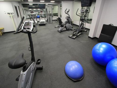 a gym with several exercise bikes and exercise balls at Sawridge Inn and Conference Centre Edmonton South in Edmonton