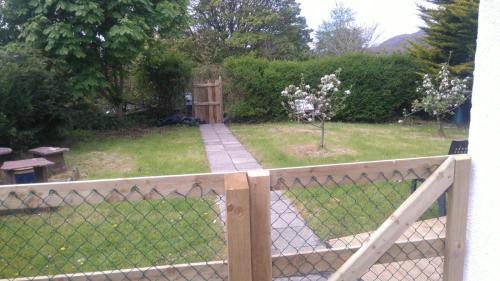 a fence with a garden in the background at Murrevagh Mealog in Tooreen