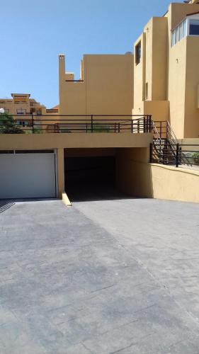 a parking lot in front of a house with a garage at El Faro Puerto Rey in Vera