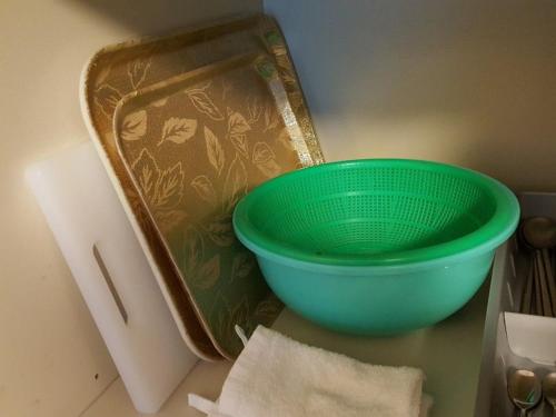 a green bowl sitting on top of a counter at Haeundae Bada Condo in Busan