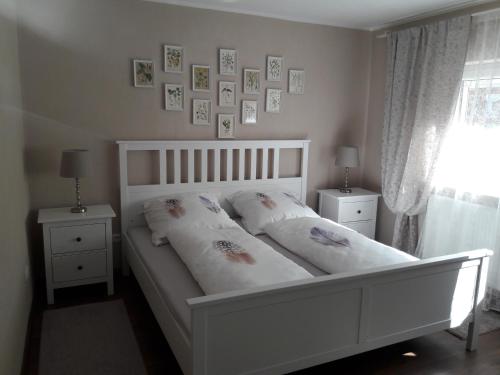 a bedroom with a white bed with pillows on it at Ferienwohnung Philipps in Kitzingen