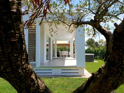 a view of a house through two trees at Villaggio La Pescaccia in San Clemente