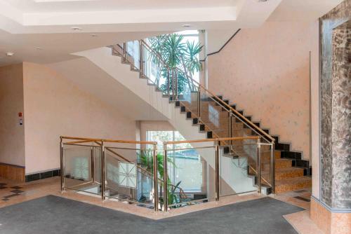 a spiral staircase in a building with plants at Optima Kremenchuk in Kremenchuk