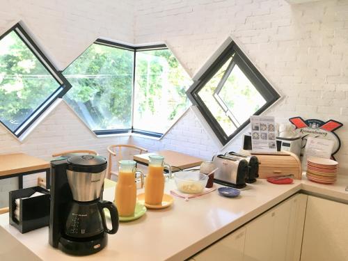 a kitchen counter with a coffee maker on it at Mir Guesthouse in Jeju