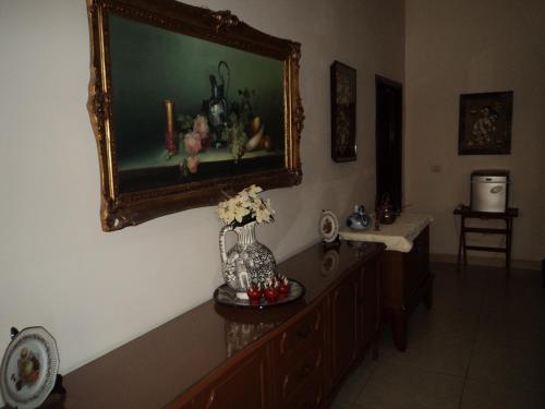 a room with a vase of flowers and a painting on the wall at Mansion Serrano Hotel in El Fuerte