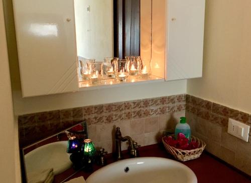 a bathroom sink with glasses on a cabinet at Locanda della Lavanda in San Clemente