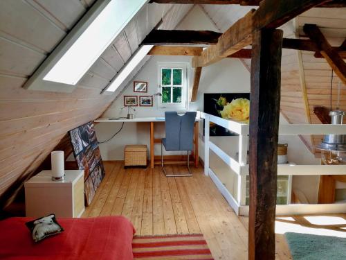 a room with a loft bed and a desk at Ferienhaus Landhaus Am Hirtzborn in Marburg an der Lahn