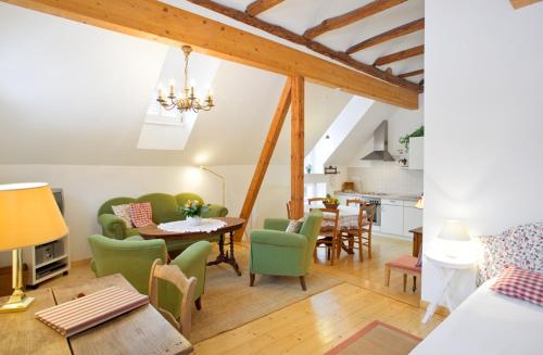 a living room with green chairs and a table at Romantik Hotel Landhaus Bärenmühle in Frankenau