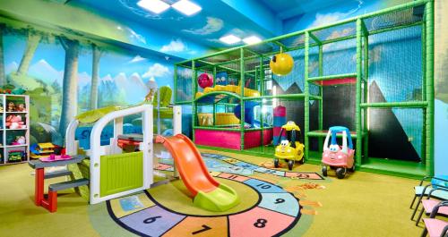 a play room with a slide and a playground at Borowy Dwór- Biznes, Spa & Fun in Szaflary