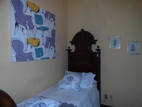 a bedroom with a bed and a painting on the wall at Albergo & Ristorante Selvatico in Rivanazzano