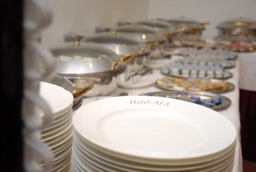a group of plates and pans on a table at Hotel Afa in Pristina