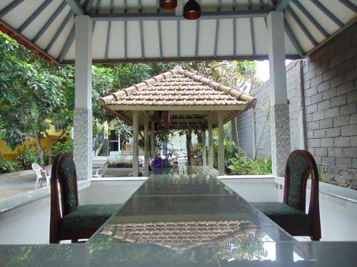 a table with two chairs and a gazebo at ZONA Homestay in Selong