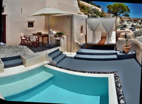 a house with a swimming pool with stairs and a table at Abelis Canava Luxury Suites in V&oacute;thon